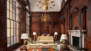 A grand room with a chandelier, large windows, and a fireplace. - Raffles London at The OWO (London)