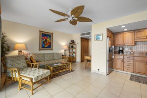 A living room with a sofa, chairs, a coffee table, and a ceiling fan. - Kihei Beach, #305 1 Bedroom Condo by RedAwning (Kihei)
