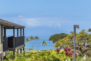 A building with a balcony overlooking a coastal view.