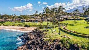 A coastal resort with beachfront properties, a well-maintained lawn, and a view of the ocean. - Wailea Elua by Coldwell Banker Island Vacations (Kihei)