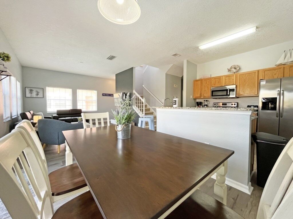 A modern kitchen with wooden cabinets, stainless steel appliances, and a central island.