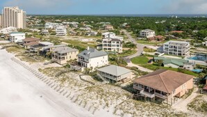 An aerial view of a coastal residential area with beachfront properties, including houses with balconies and a beach access walkway. - Sweet Spot - Newly Renovated, Heated Pool, Golf Cart, Deeded Beach Access! (Miramar Beach)