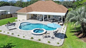 A backyard with a swimming pool, a hot tub, and outdoor furniture. - Sweet Spot - Newly Renovated, Heated Pool, Golf Cart, Deeded Beach Access! (Miramar Beach)