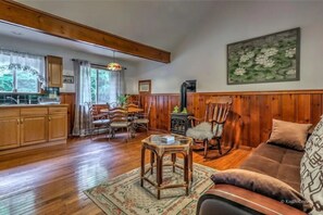 Relax in this inviting living room with a comfortable sofa, coffee table, and dining area.