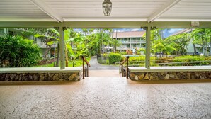 A covered walkway leading to a building with a sign prohibiting alcoholic beverages.