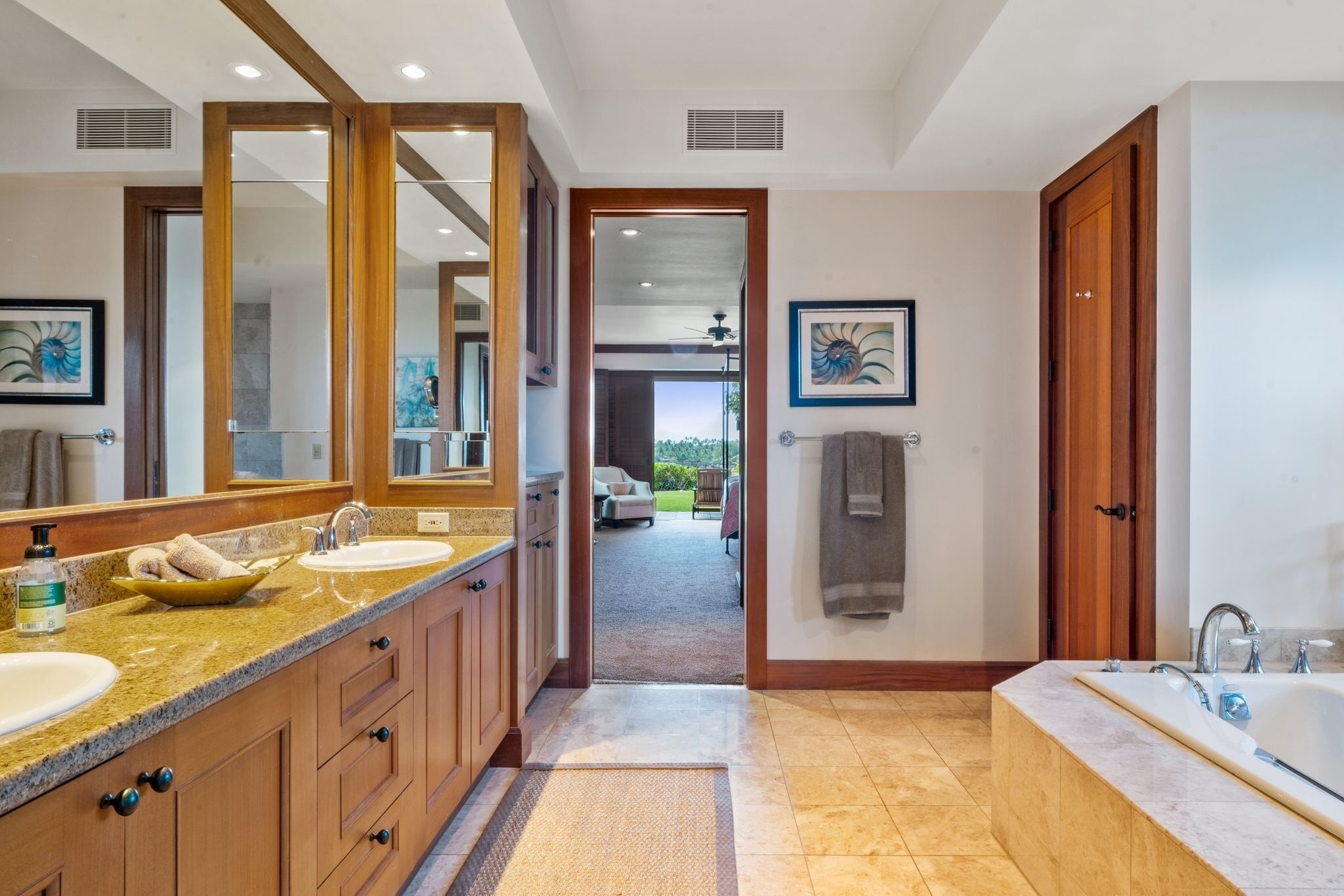 A modern bathroom with a double sink vanity, a large mirror, and a walk-in shower.