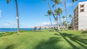 A resort with a pool area, palm trees, and a view of the ocean. - Sugar Beach Resort, #524^ 1 Bedroom Condo by RedAwning (Kihei)
