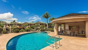 A resort pool area with a clear blue pool, lounge chairs, and a bar area. - Big Island Waikoloa Fairways by Coldwell Banker Island Vacations (Waikoloa)