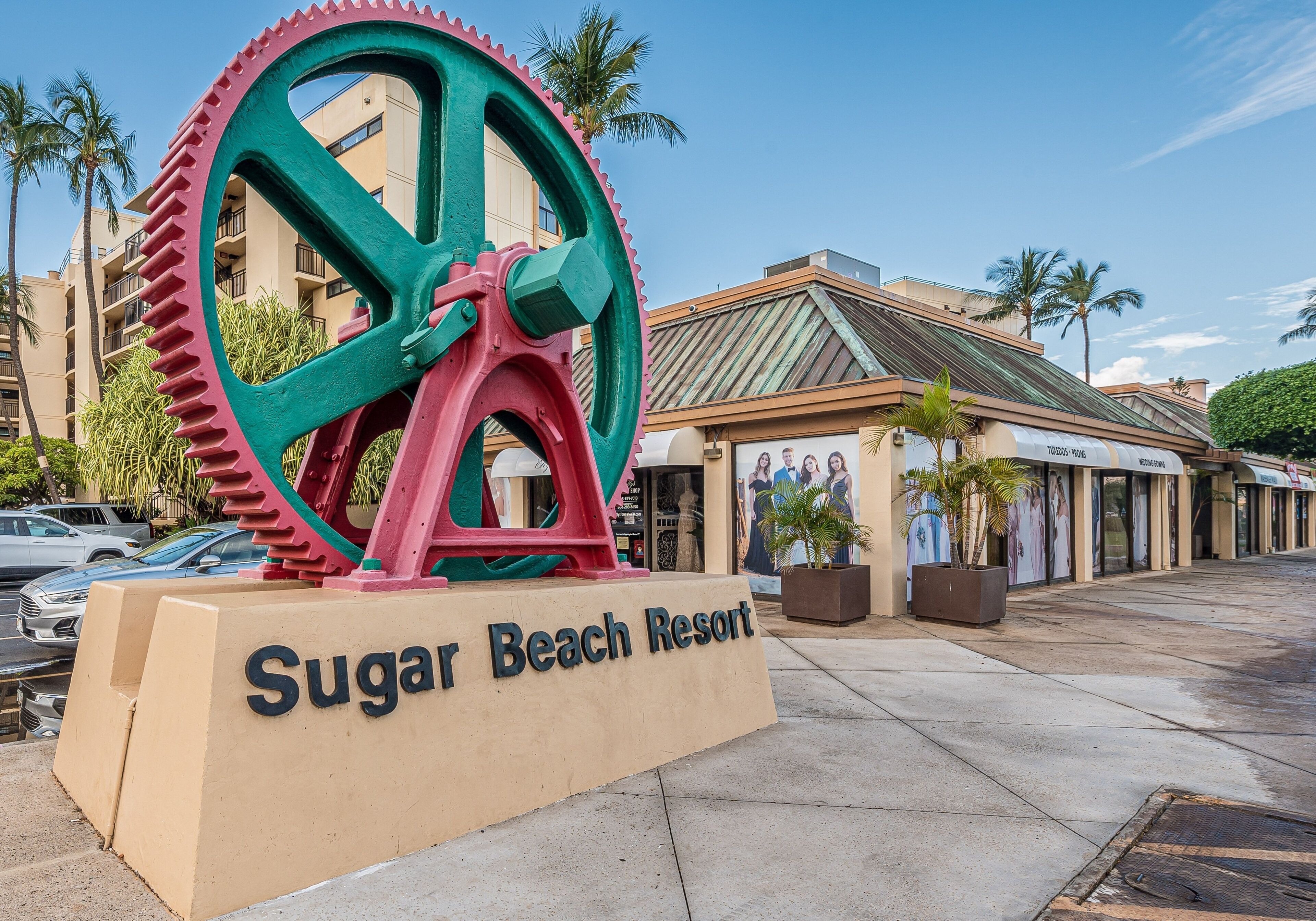 A large mechanical gear structure with a sign reading 'Sugar Beach Resort'.