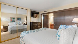 A hotel room with a large bed, a wardrobe, a dresser, a television, and a mirror. - Sugar Beach Resort, #130 1 Bedroom Condo by RedAwning (Kihei)