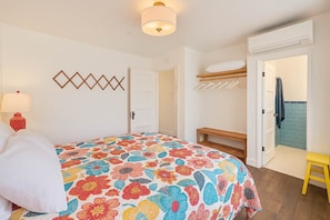 A bedroom with a bed, a bedside table, a lamp, a wardrobe, and a bench. - New! Spacious Detached Home | Perfect Location (Avalon)