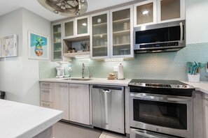 A modern kitchen with stainless steel appliances, a dishwasher, and a microwave. - Wailea Elua, #2106 2 Bedroom Condo by RedAwning (Kihei)