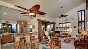 A spacious living area with a dining table, chairs, and a ceiling fan. - Wailea Ekahi, #22d 1 Bedroom Condo by RedAwning (Kihei)