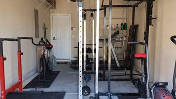 Work out in style with a fully equipped gym featuring a squat rack, bench press, and cable machine.