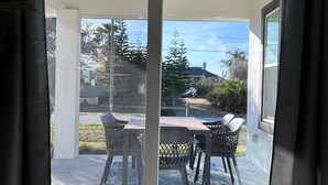 Quarto moderno com porta de correr de vidro que dá para um terraço ao ar livre.