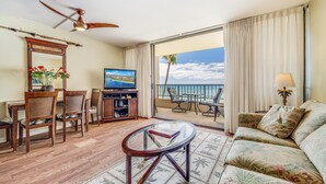 A hotel room with a balcony, a television, a dining area, and a sofa. - Sugar Beach Resort, #418 1 Bedroom Condo by RedAwning (Kihei)