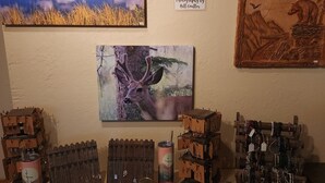 A display of jewelry and art on a wall.