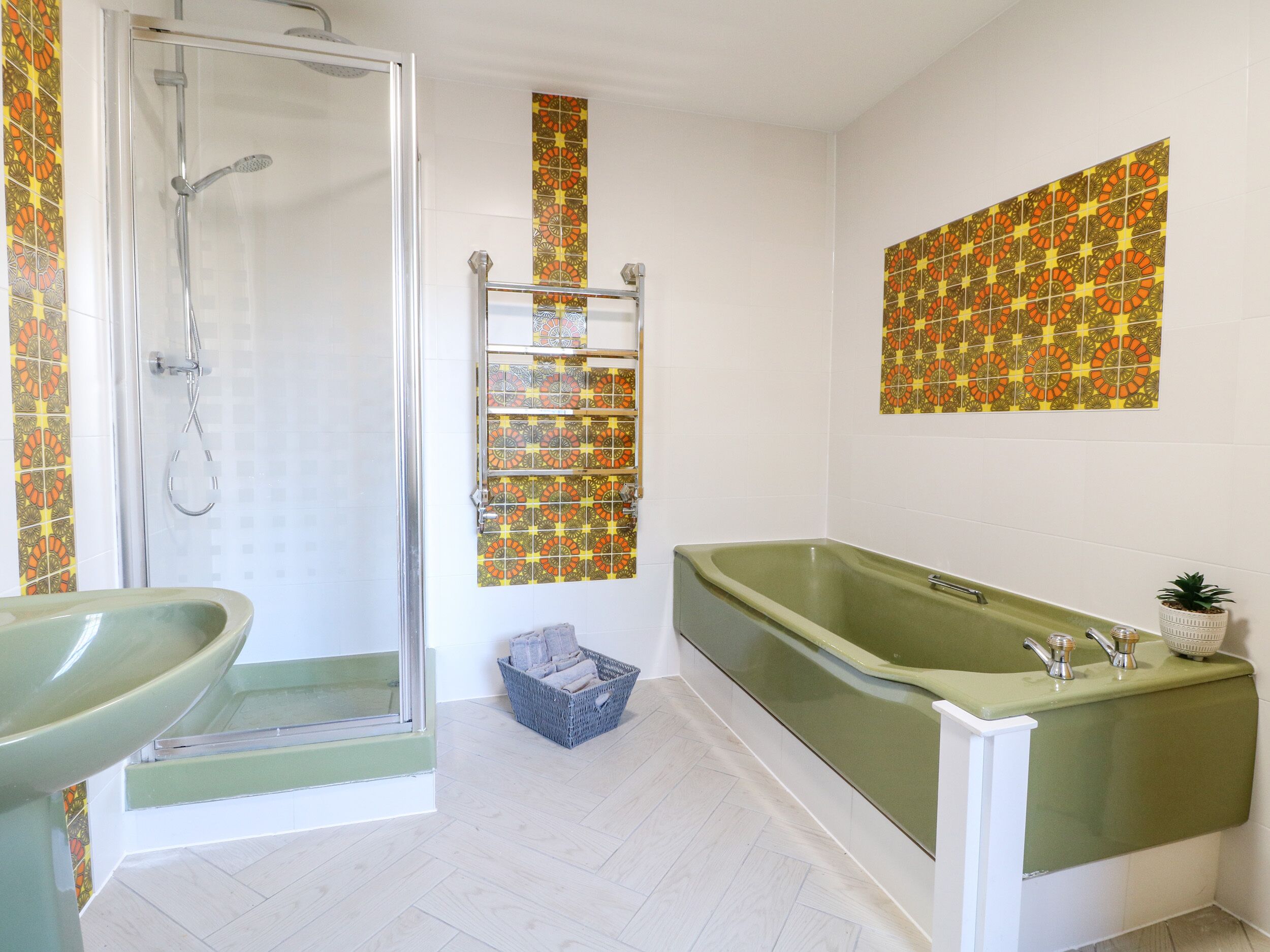 A bathroom with a shower, a sink, and a bathtub.