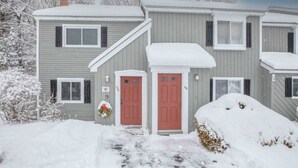 A two-story building with a red door and a small porch area. - Modern Townhome- Walk to Brewery (Woodstock)
