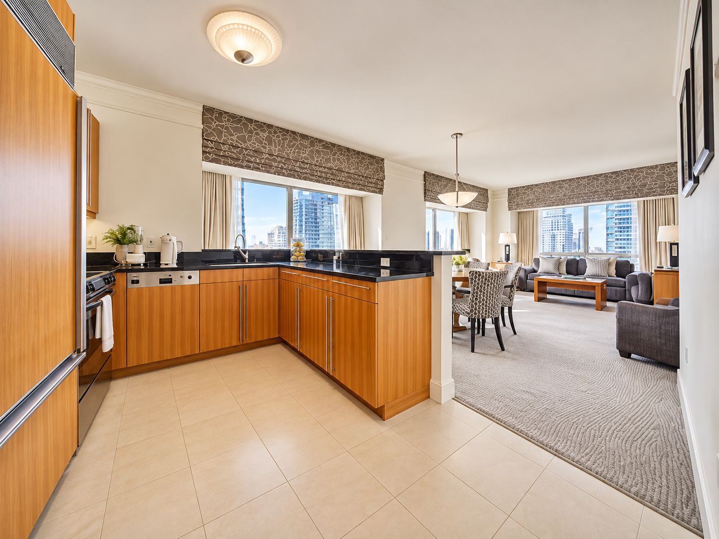 A modern apartment with a kitchen, dining area, and living room.