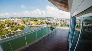 A balcony with a view of a marina, a river, and a cityscape. - Pacifika Apartments (Mazatlán)
