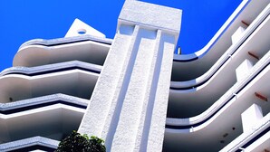 A modern building with multiple balconies and a prominent central column. - Tamaran (San Bartolomé de Tirajana)