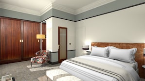 Une chambre d’hôtel avec un grand lit, une armoire en bois, un fauteuil à motifs et une table de chevet avec une lampe.
