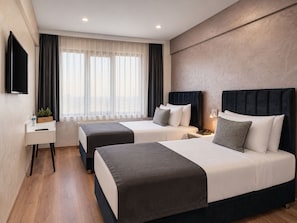 A hotel room with two beds, a desk, a TV, and a window with curtains. - Istanbul Efes Hotel (Istanbul)