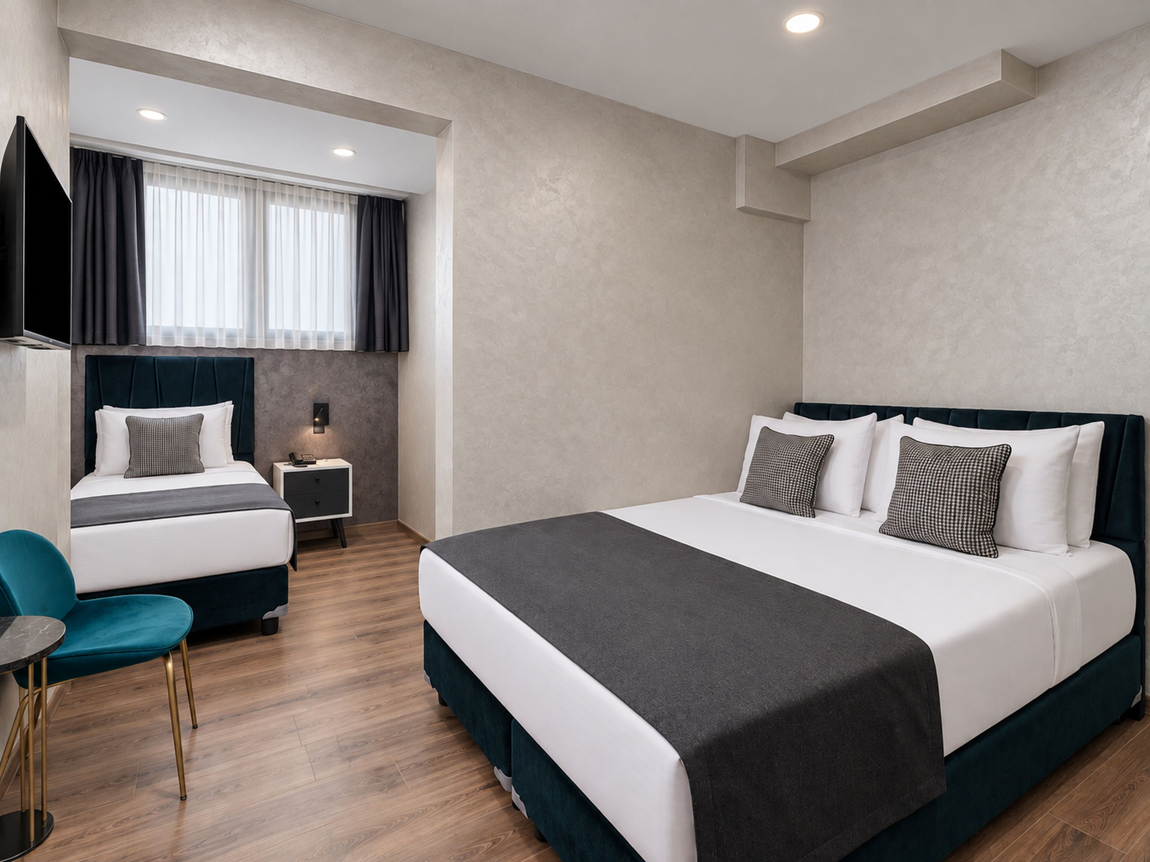 A modern hotel room with a large bed, a desk, and a chair.