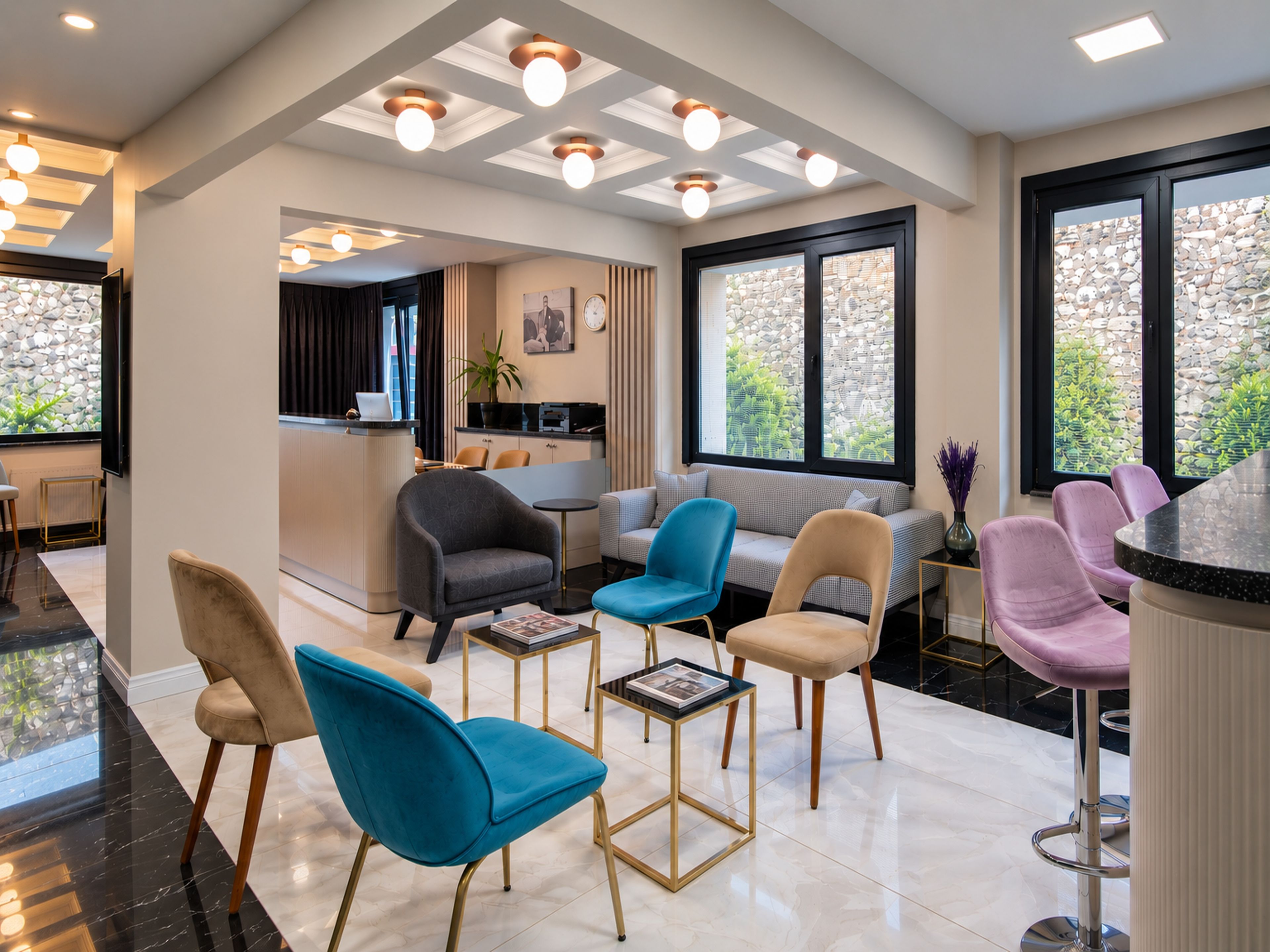 A modern interior with a seating area, a kitchen, and large windows.