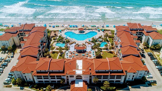 A resort with multiple buildings, a central pool area, and a beach view. - Elegant Beach Escape, Warm, Comfy Cozy, Family fun, Massage Chair, Retro Games (North Topsail Beach)