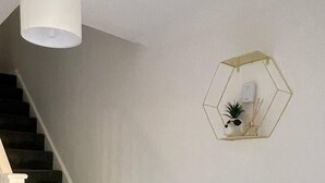 A staircase with dark carpeted steps leading to a landing. - Lovely 2-bed House in Rochester (Rochester)