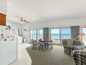 Enjoy ocean views from the spacious living area with a dining table and comfortable seating.