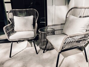Two wicker chairs with cushions, a small round table, and a wicker basket. - Luxury Downtown Home w/ Hot Tub Near Lake in Holly (Austin)