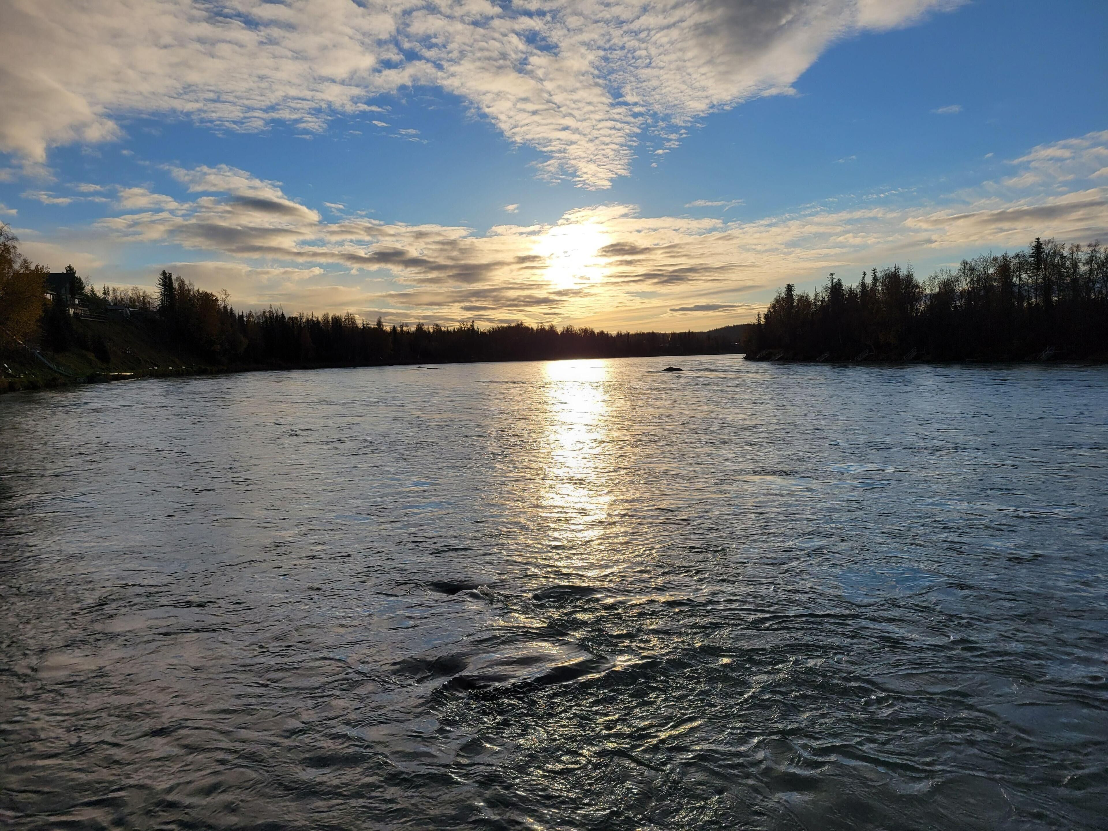 A river with a sunset in the background.