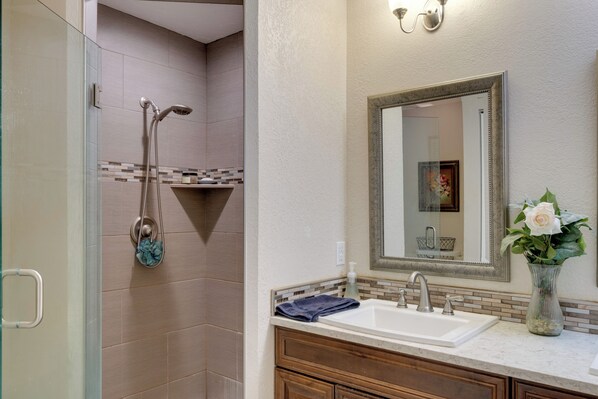 A bathroom with a shower, sink, and vanity. - 4 Mi to Port Charlotte Beach Park: Gem w/ Pool (Port Charlotte)