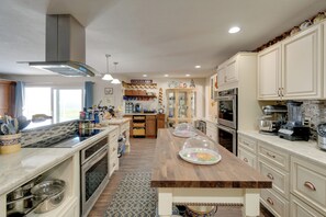 A kitchen with wooden countertops, a central island, and a coffee station. - 4 Mi to Port Charlotte Beach Park: Gem w/ Pool (Port Charlotte)