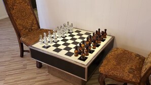 A chessboard set up on a table with ornate chairs. - Huge 4,080 SqFt  cul-de-sac Home (Mesa)