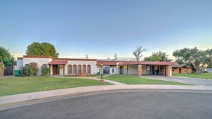 A two-story building with a red-tiled roof, arched windows, and a small fountain in front. - Huge 4,080 SqFt  cul-de-sac Home (Mesa)