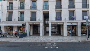 A building with multiple storefronts, including a restaurant named 'Nata Fina' and a shop called 'J.S. Cork'. - Downtown apartment w/terrace (Lisboa)