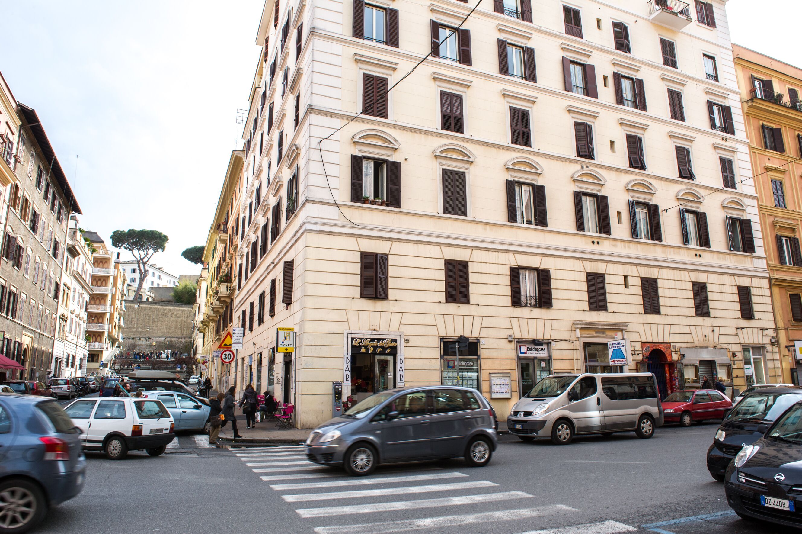 A multi-story building with a classic architectural style, featuring a ground-floor shop and a visible entrance.