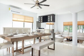 Enjoy meals with family and friends in the dining area, featuring a table for four and a comfortable bench.