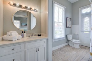 A bathroom with a vanity, sink, mirror, and toilet. - Beauty on Ball - Main 2 - King Bed, Near restaurants and beach!! (Galveston)