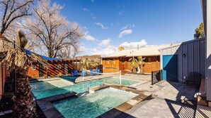 A pool area with a hot tub, lounge chairs, and a wooden deck. - Hangar 18 @ Area 51 | Themed | Pet Friendly (Hurricane)