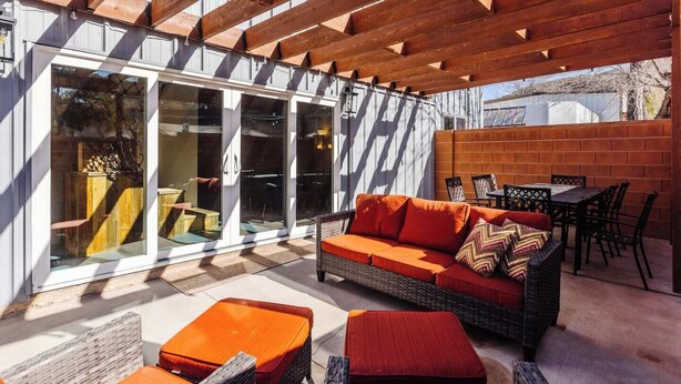 A covered outdoor seating area with a sofa, chairs, and a table. - Hangar 18 @ Area 51 | Themed | Pet Friendly (Hurricane)