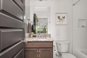 Bathtub, hair dryer, soap, shampoo