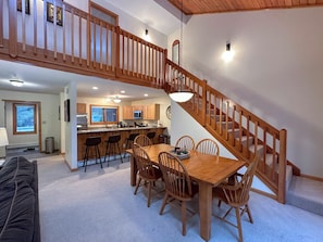 A sunny open concept space with large dining table that seats 8.