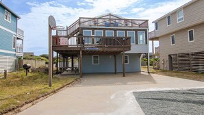 A two-story house with a balcony, a satellite dish, and a garage.