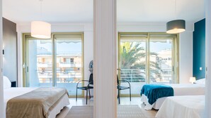 A hotel room with two beds, a large window, and a view of the city. - PANORAMIC SEA VIEW - 2-Br Apartment Mouré Rouge (Cannes)