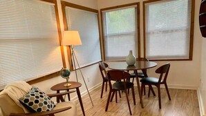 A cozy living room with a sofa, a small round table, and a lamp.